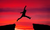 Man jump through the gap on sunset fiery background. Element of